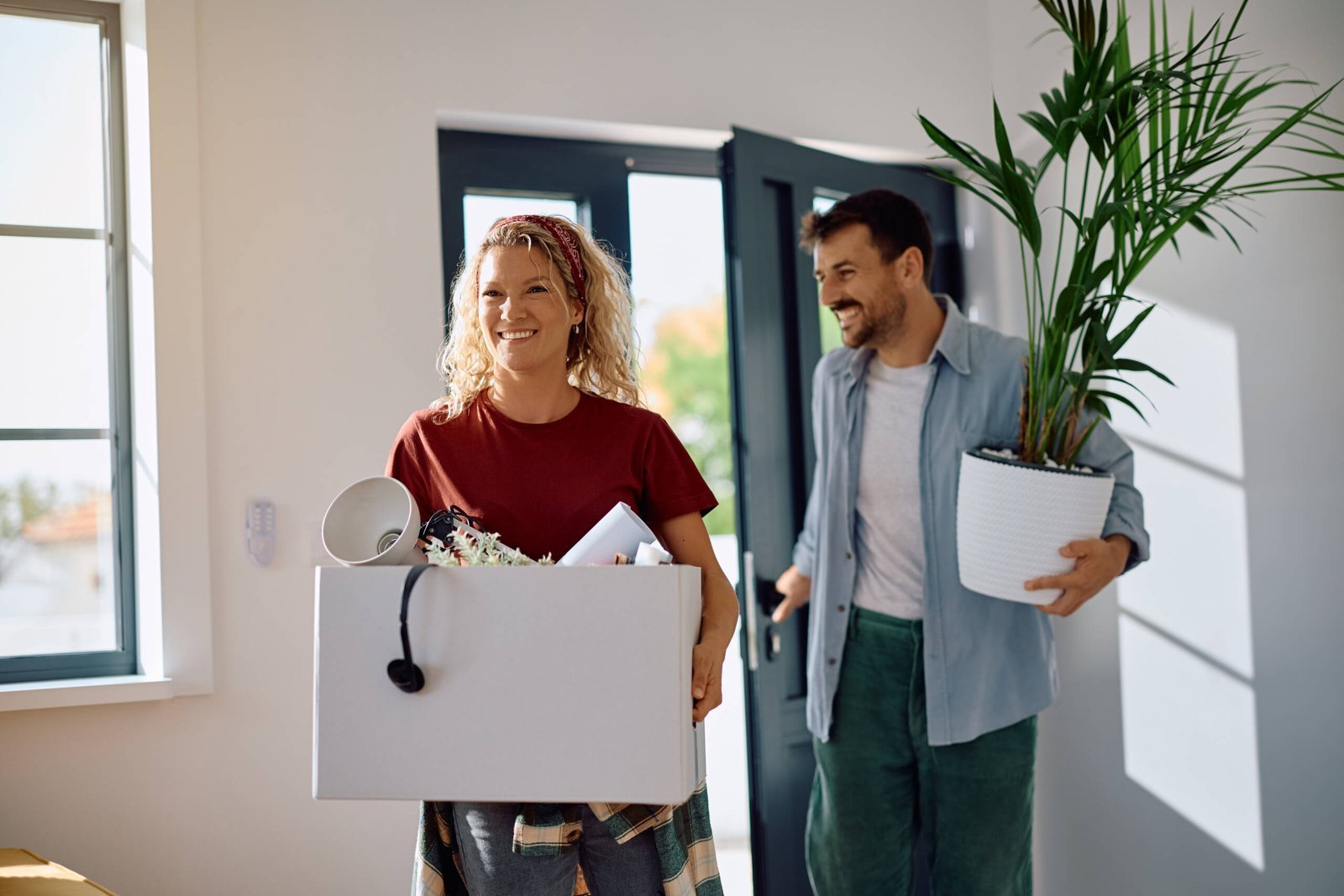 happy couple bringing their belongings into new ho utc scaled jpg
